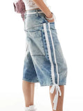 Denim skirt with white drawstring on a plain background