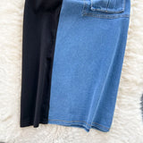 Black and blue jeans on a white fluffy surface