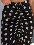 Black polka dot skirt with a close-up on a neutral background
