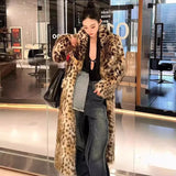 Person wearing a leopard print coat in an indoor setting