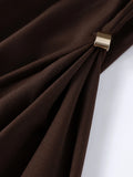 Close-up of brown fabric with a gold tie-back on a white background