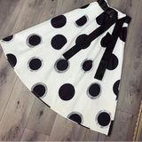 Black and white polka dot skirt on a wooden floor