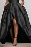 Black evening gown with a high-low skirt on a neutral background